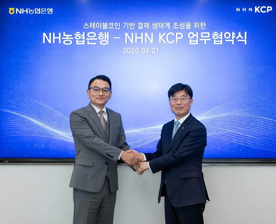 사진: NHN KCP 박준석 대표이사(왼쪽)와 NH농협은행 김주식 부행장이 악수를 하고 있다
